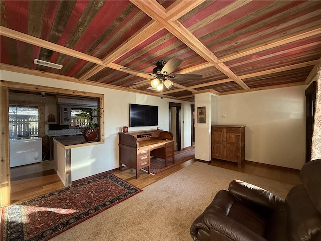 living room featuring ceiling fan and coffered ceiling