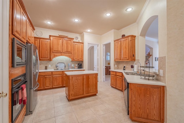 kitchen featuring backsplash, a center island, black appliances, sink, and ornamental molding