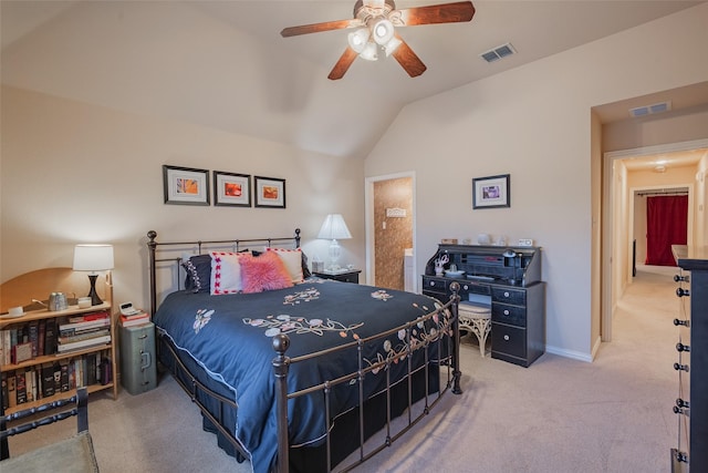 bedroom with ceiling fan, light colored carpet, ensuite bath, and lofted ceiling