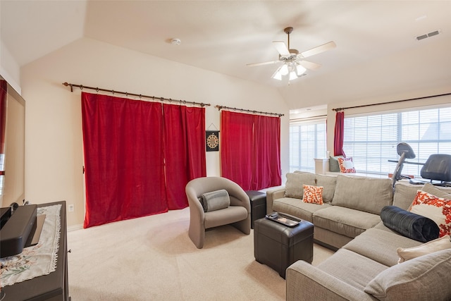 living room with ceiling fan, light colored carpet, and lofted ceiling