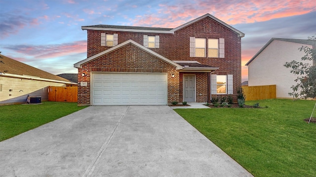 view of front property with a lawn, central air condition unit, and a garage