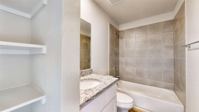 full bathroom featuring toilet, tiled shower / bath combo, and vanity