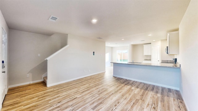 unfurnished living room featuring light wood-type flooring