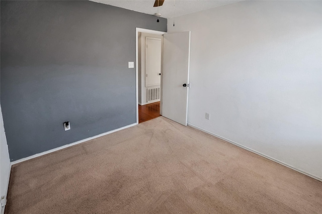 carpeted spare room with ceiling fan