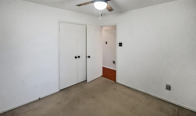 unfurnished bedroom featuring light carpet, ceiling fan, and a closet