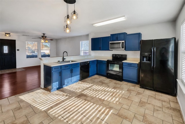 kitchen featuring a wealth of natural light, sink, blue cabinetry, and black appliances