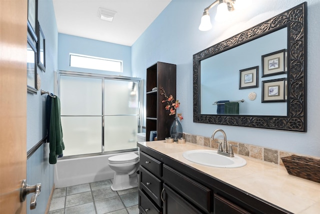 full bathroom featuring plenty of natural light, combined bath / shower with glass door, vanity, and toilet