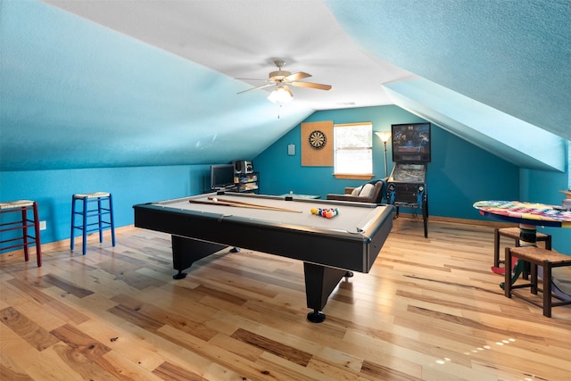 recreation room with ceiling fan, lofted ceiling, light wood-type flooring, a textured ceiling, and pool table