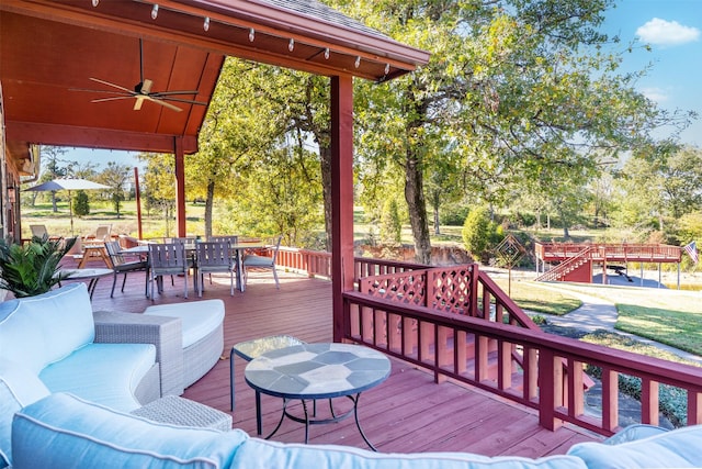 wooden terrace featuring ceiling fan and an outdoor hangout area