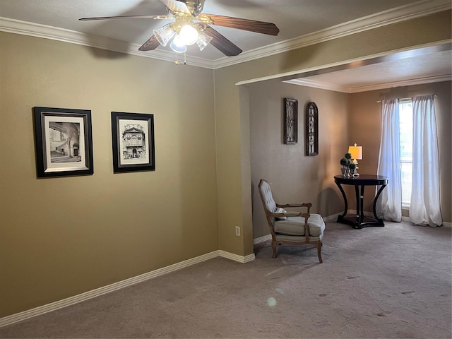 sitting room with ceiling fan, carpet, and crown molding