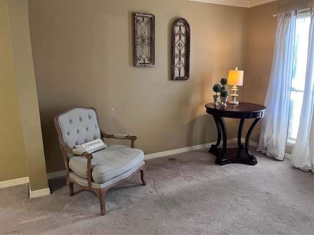 living area with light colored carpet and ornamental molding