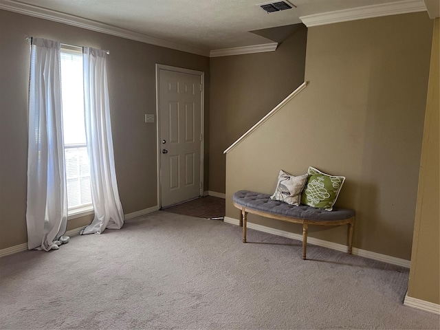 foyer featuring ornamental molding and light carpet