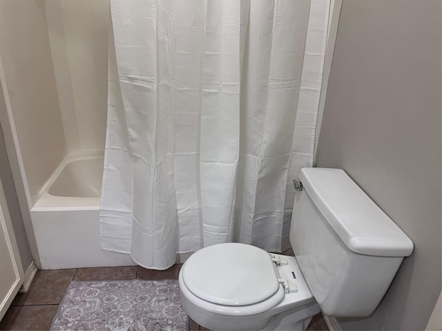 bathroom featuring toilet, tile patterned flooring, and shower / bath combo