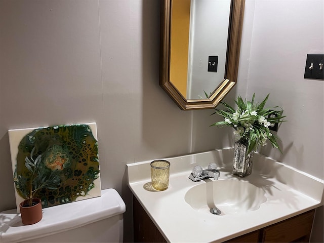 bathroom featuring toilet and vanity