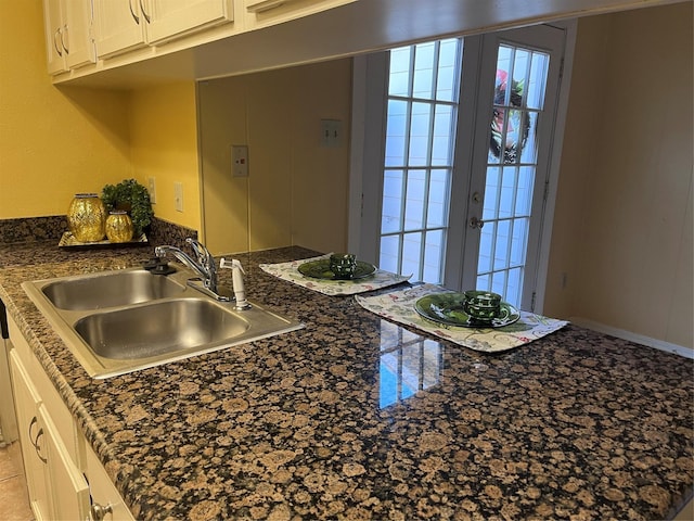 kitchen featuring sink, white cabinetry, and french doors