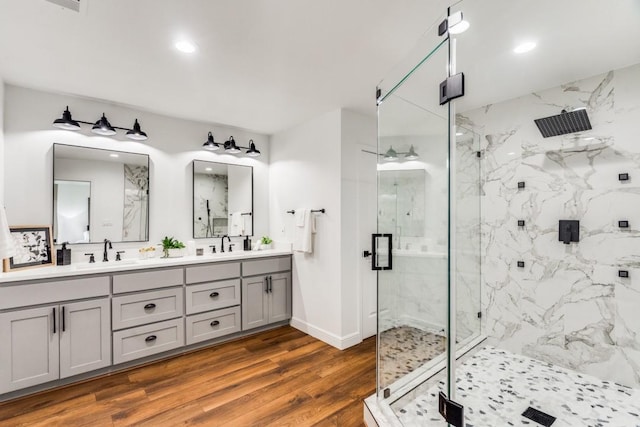 bathroom featuring hardwood / wood-style floors, an enclosed shower, and vanity