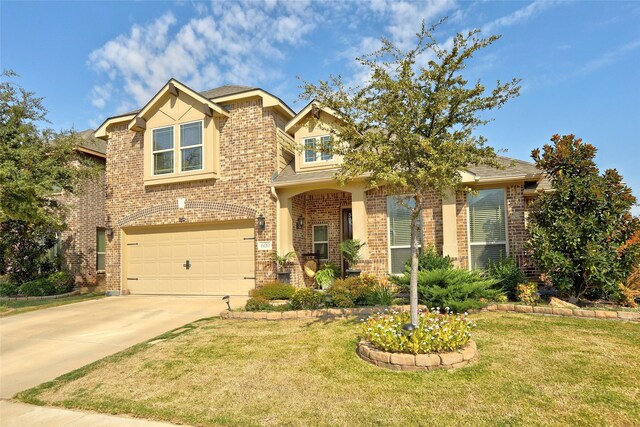 view of front of house with a front yard and a garage