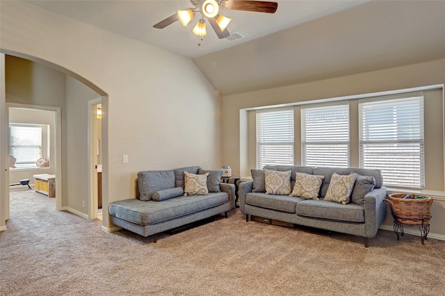 carpeted living room with ceiling fan, lofted ceiling, and a healthy amount of sunlight