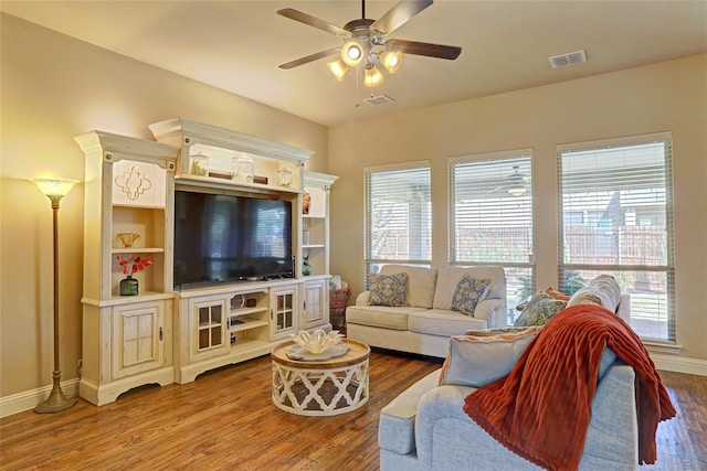 living room featuring ceiling fan and hardwood / wood-style floors