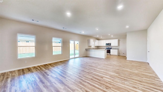 unfurnished living room with light wood-type flooring