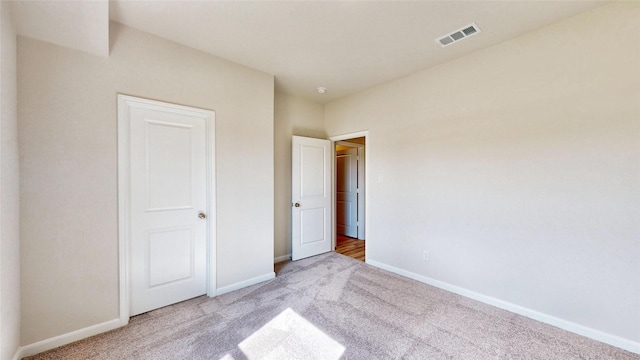 unfurnished bedroom featuring light colored carpet