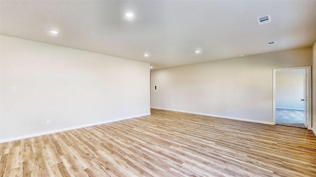 empty room with light hardwood / wood-style flooring