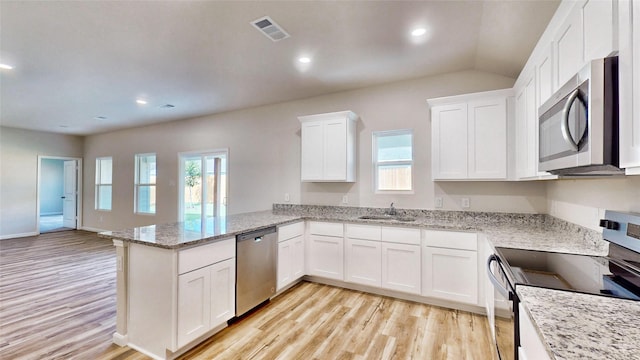 kitchen featuring kitchen peninsula, white cabinetry, light hardwood / wood-style flooring, appliances with stainless steel finishes, and light stone counters