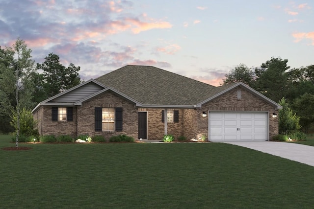 view of front of property with a garage and a yard