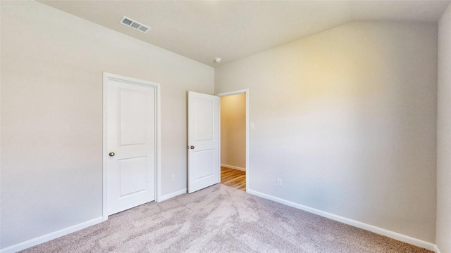 unfurnished bedroom featuring light carpet