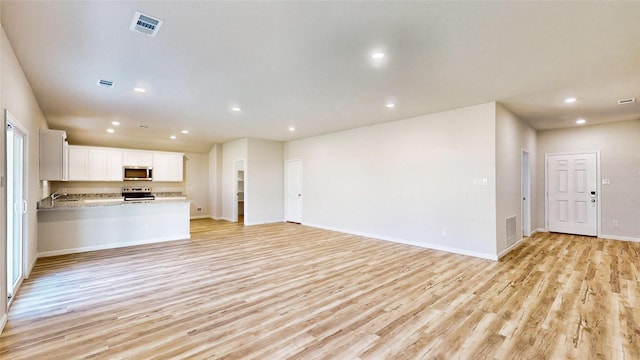 unfurnished living room with light hardwood / wood-style flooring