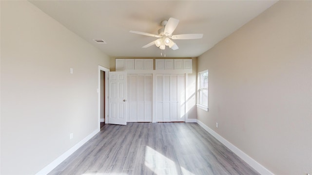 unfurnished bedroom featuring ceiling fan, a closet, and light wood-type flooring