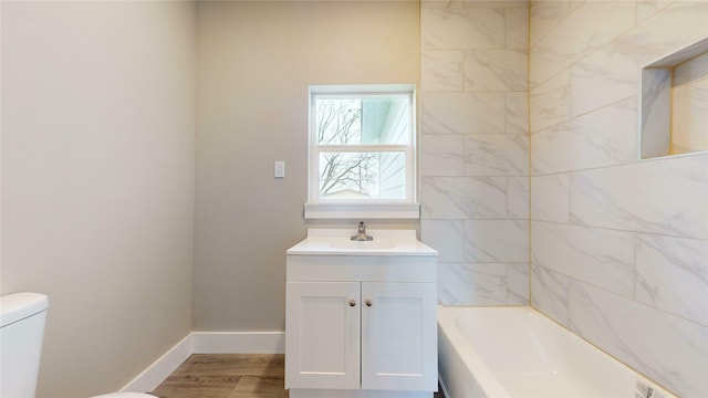 bathroom featuring toilet, hardwood / wood-style flooring, and vanity