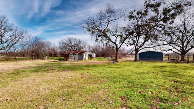 view of yard with a rural view and an outdoor structure