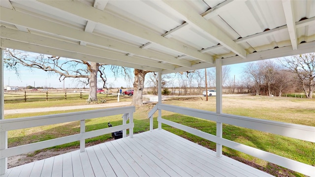 deck featuring a rural view and a lawn