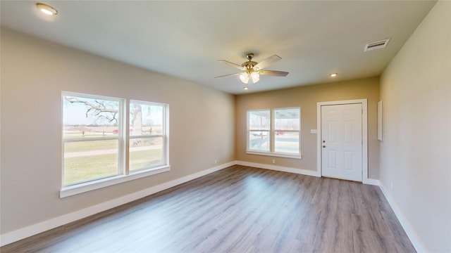 spare room featuring ceiling fan and light hardwood / wood-style flooring