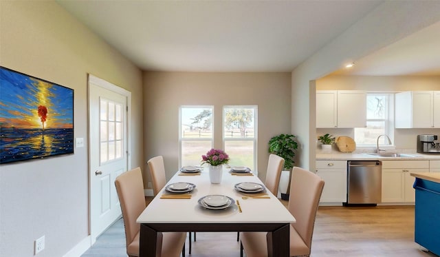 dining room with sink and light hardwood / wood-style floors