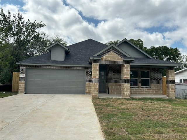 view of front of property featuring a garage and a front lawn