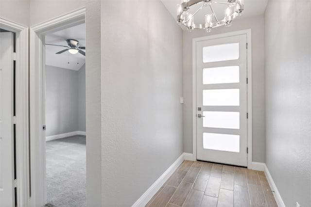 foyer featuring a healthy amount of sunlight and ceiling fan with notable chandelier