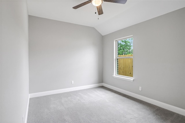 unfurnished room featuring lofted ceiling, ceiling fan, and carpet floors