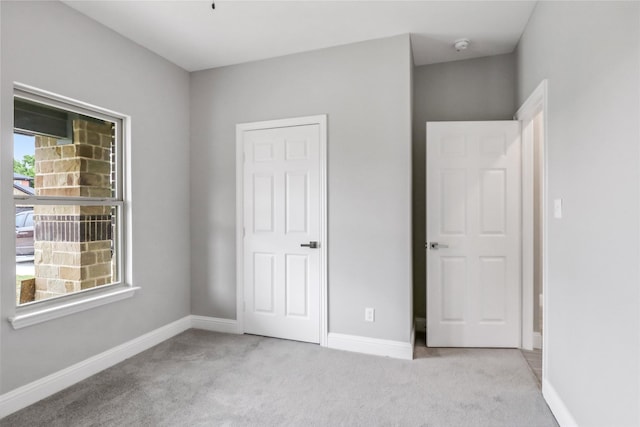 unfurnished bedroom with light carpet