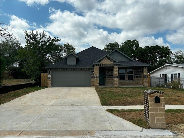 view of front of house with a garage and a front lawn