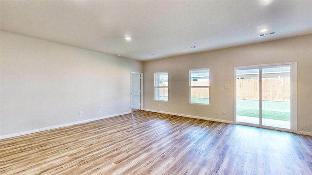 unfurnished room with a wealth of natural light and light hardwood / wood-style floors