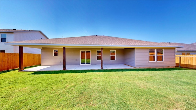 rear view of house featuring a patio area and a lawn