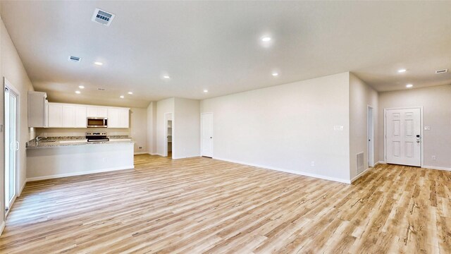 unfurnished living room with light hardwood / wood-style flooring