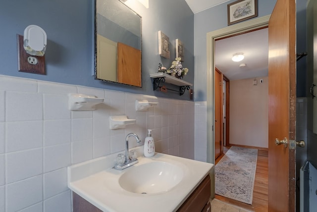 bathroom with tile walls and vanity