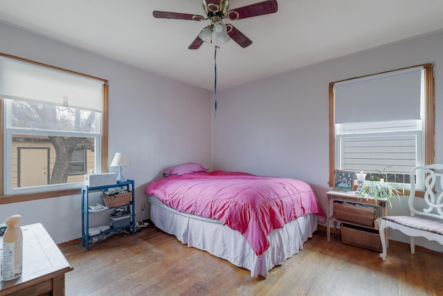 bedroom with ceiling fan and hardwood / wood-style floors