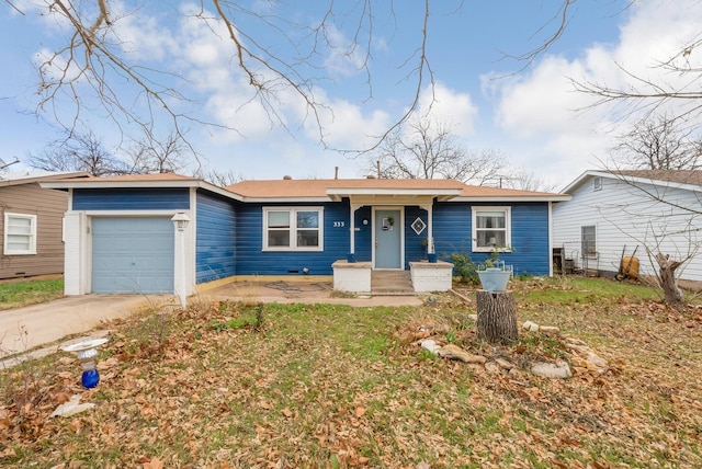 single story home with a garage and concrete driveway