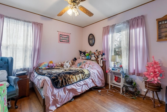 bedroom with ceiling fan and wood-type flooring