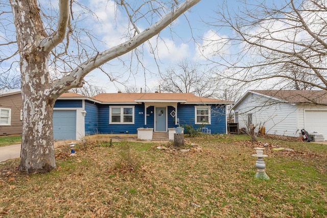 single story home with a front yard and a garage