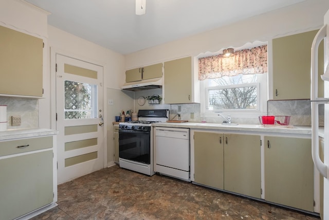 kitchen with decorative backsplash, sink, and white appliances